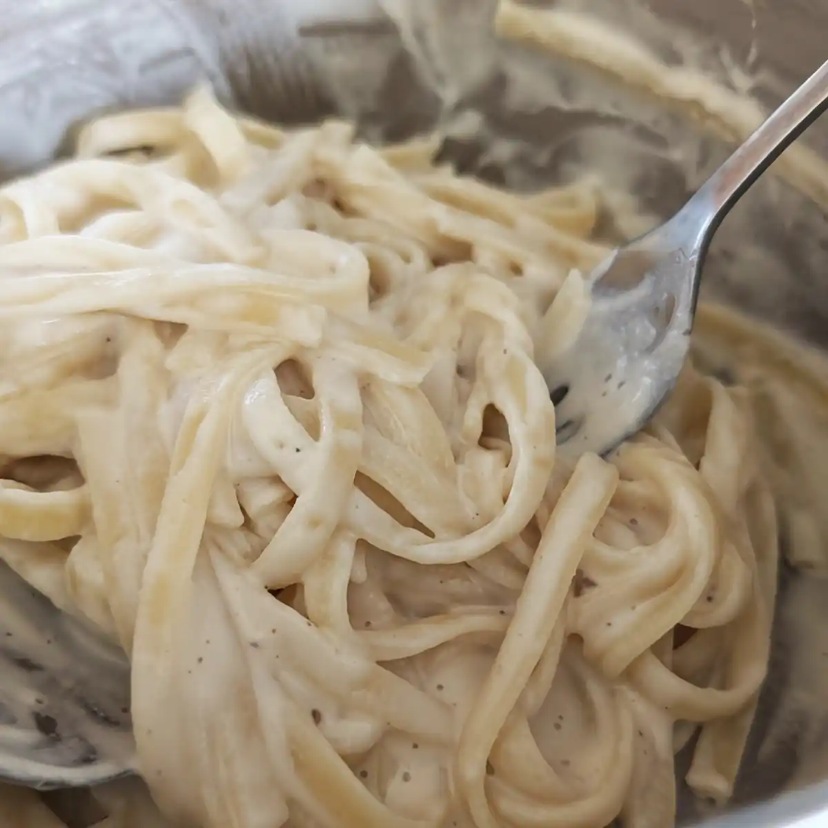 Finishing Fettuccine Alfredo in a Saucepan
